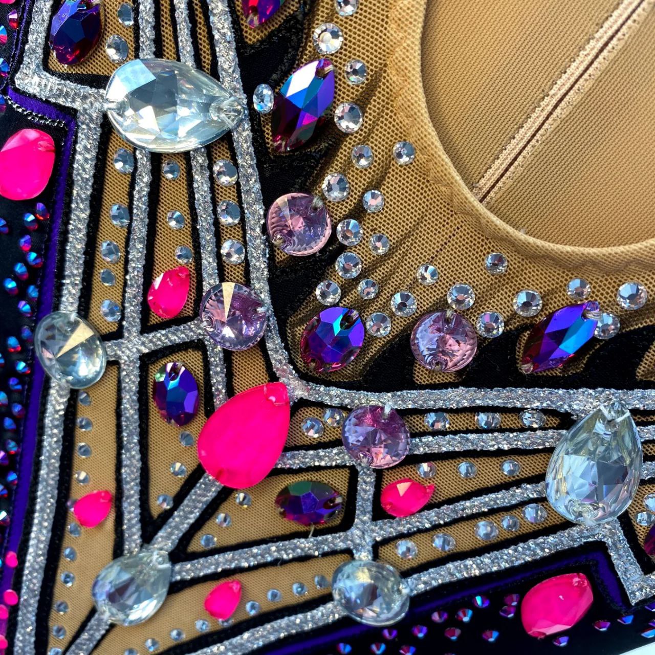 Melody An elegant original leotard for performances and competitions in black, neon pink, purple colors with silver patterns, sleeveless, with a skirt - will perfectly complement the image of a gymnast and will stand out and shine brightly on stage